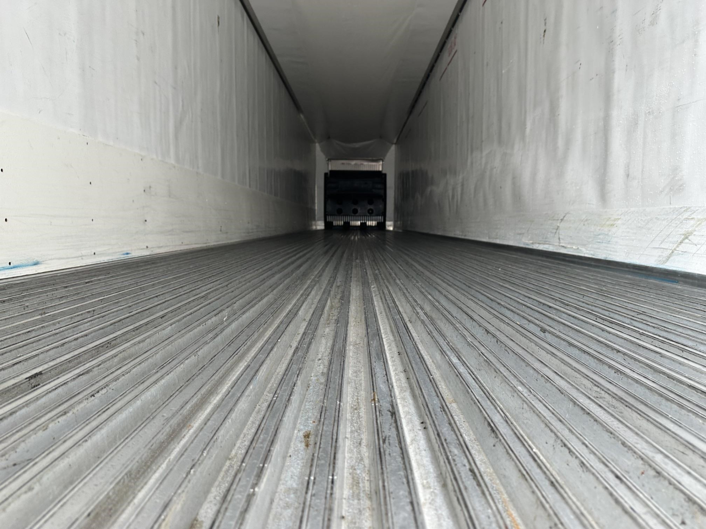 Trailer interior showing ribbed metal floor and rear doors of a 2020 Utility 3000R refrigerated trailer