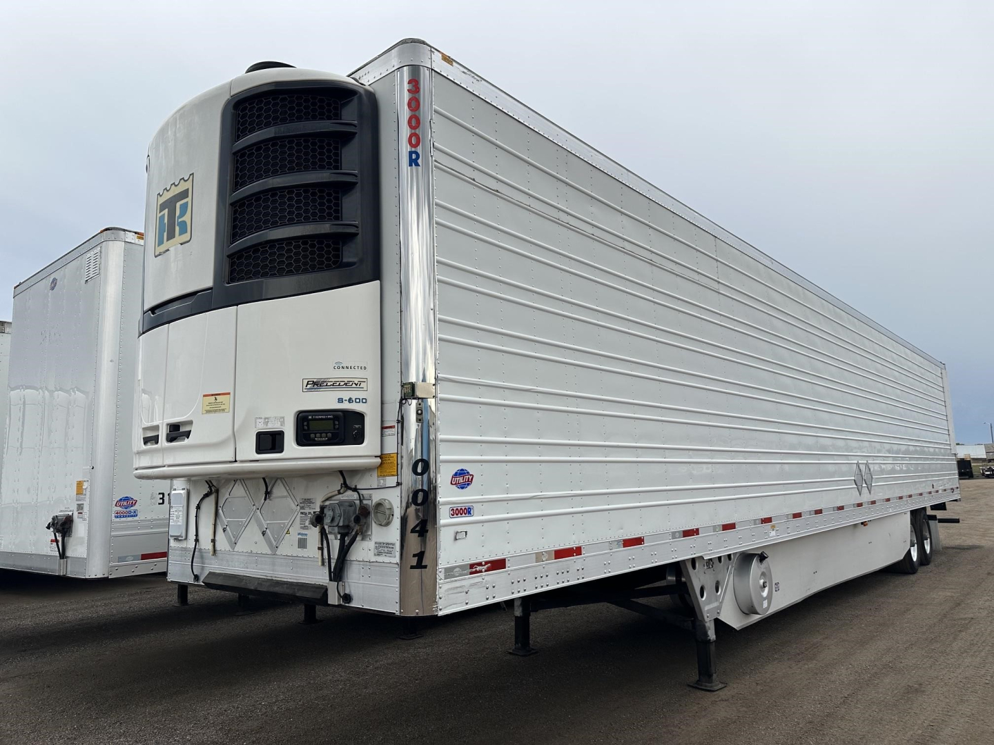 Utility 3000R trailer with Thermo King reefer unit showing side panels and landing gear.