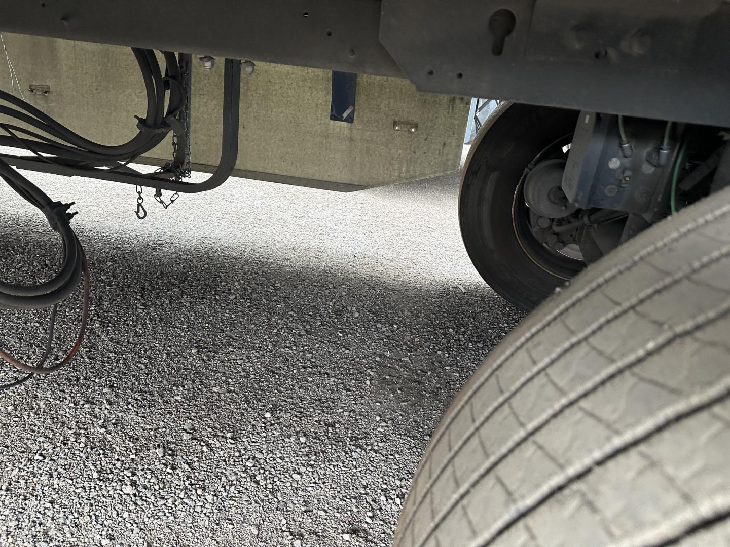 Trailer undercarriage with dual rear tires, wiring and suspension components visible; part of a Utility 3000R reefer trailer.