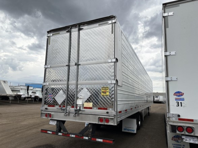 Trailer rear view showing Utility 3000R refrigerated trailer with diamond plate rear doors, twin rear lights, and reflective tape.