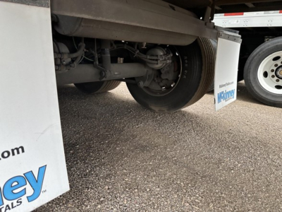 Trailer undercarriage with rear axle, suspension, and wheel visible; utility 3000R trailer components and mud flaps present.