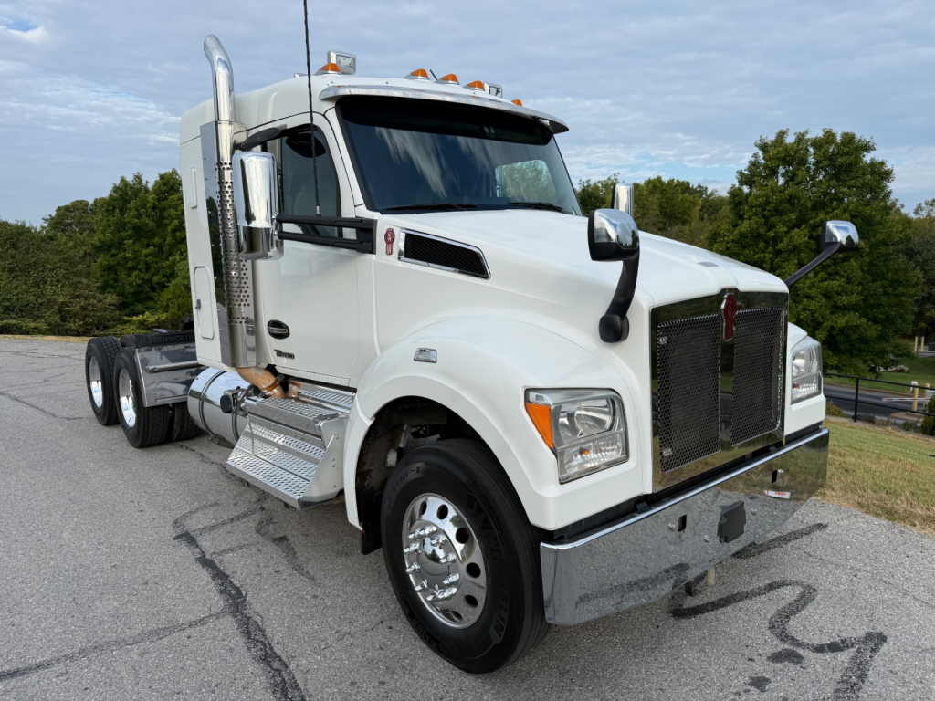 Kenworth T880S tractor cab in white side view showing front grille and large fuel tanks