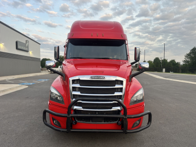 Front view of a red 2022 Freightliner Cascadia 126 conventional sleeper truck with a heavy-duty grille guard.