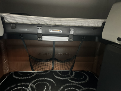 Freightliner Cascadia 126 sleeper cab interior showing storage pocket and strap handles.