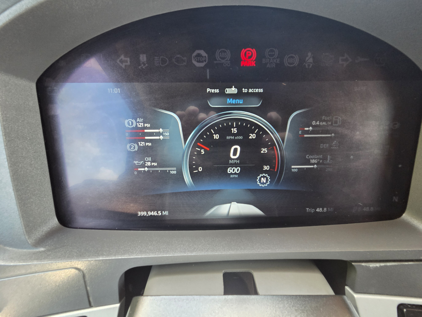 Kenworth T680 cockpit instrument cluster display showing digital gauges and odometer readout.