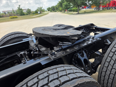 Kenworth T680 chassis view showing rear wheel region and fifth wheel mounting with visible frame, springs, and suspension.