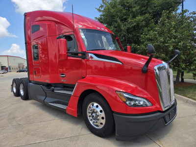 Kenworth T680 sleeper tractor in red, front three-quarter view showing cab, mirrors, chrome grille, and dual rear axles.