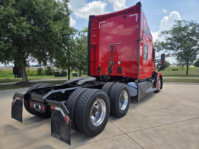 Kenworth T680 semi truck rear view showing sleeper cab and dual rear axles with mud flaps