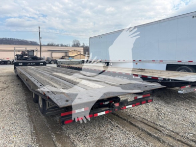 Traveling axle trailer showing flatbed ramps and dual rear lights. 2014 Landoll 440B trailer with metal deck.