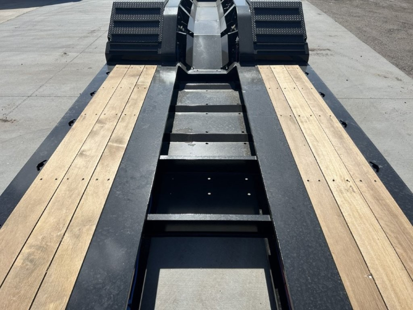 Alpha A110HDG-SF-18" LDH lowboy trailer deck showing wooden planks and center frame with gooseneck hitch area.