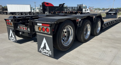 Alpha Trailers LDH 26' deck lowboy trailer showing rear triple-axle configuration and mud flaps with Alpha Trailers logo.