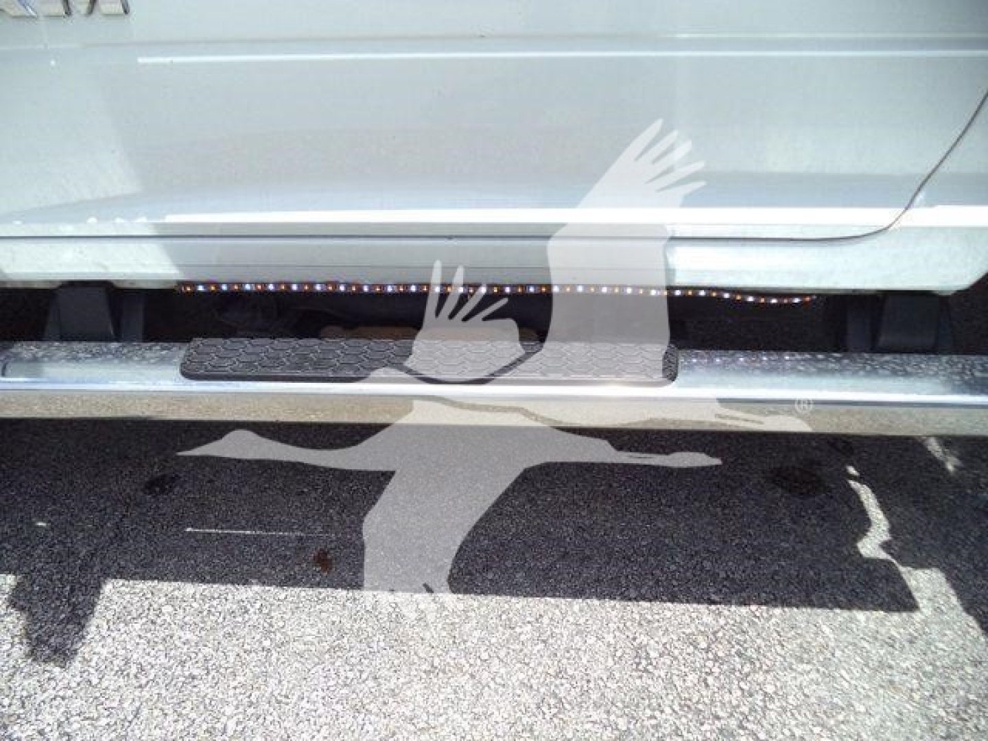 Ram 5500 rollback truck side view showing step bar and lower body with stock number tag