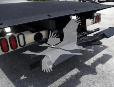 Ram 5500 rollback truck rear showing hitch, taillights, and heavy-duty frame with deck platform.
