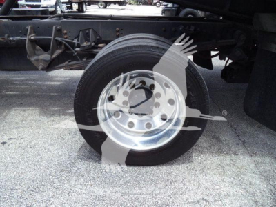 Wheel and front suspension of a Ram 5500 rollback truck showing a single steel rim and tire undercarriage components.
