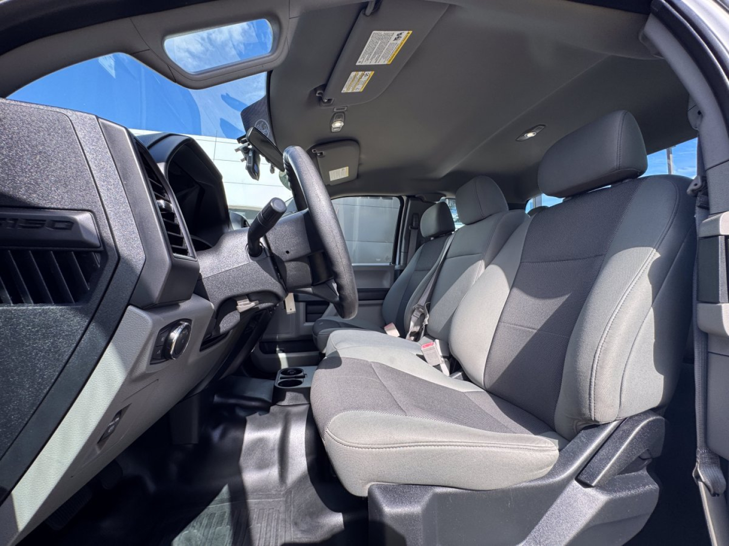 Ford F-150 2018 interior front seats driver area showing dashboard and steering wheel