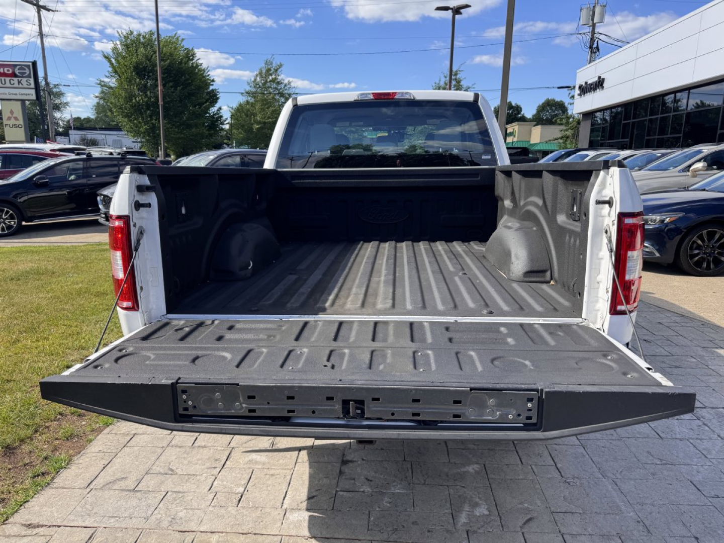 Pickup truck bed of a 2018 Ford F-150 with tailgate down, showing empty cargo area and bed ridges.