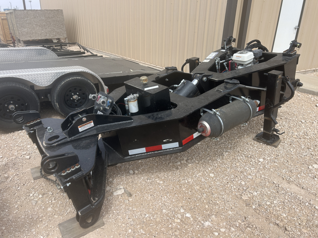 Load King SB141/2-NS-43 trailer frame showing hydraulic tank, winch, and hitch assembly with black metal framing and engine compartment.
