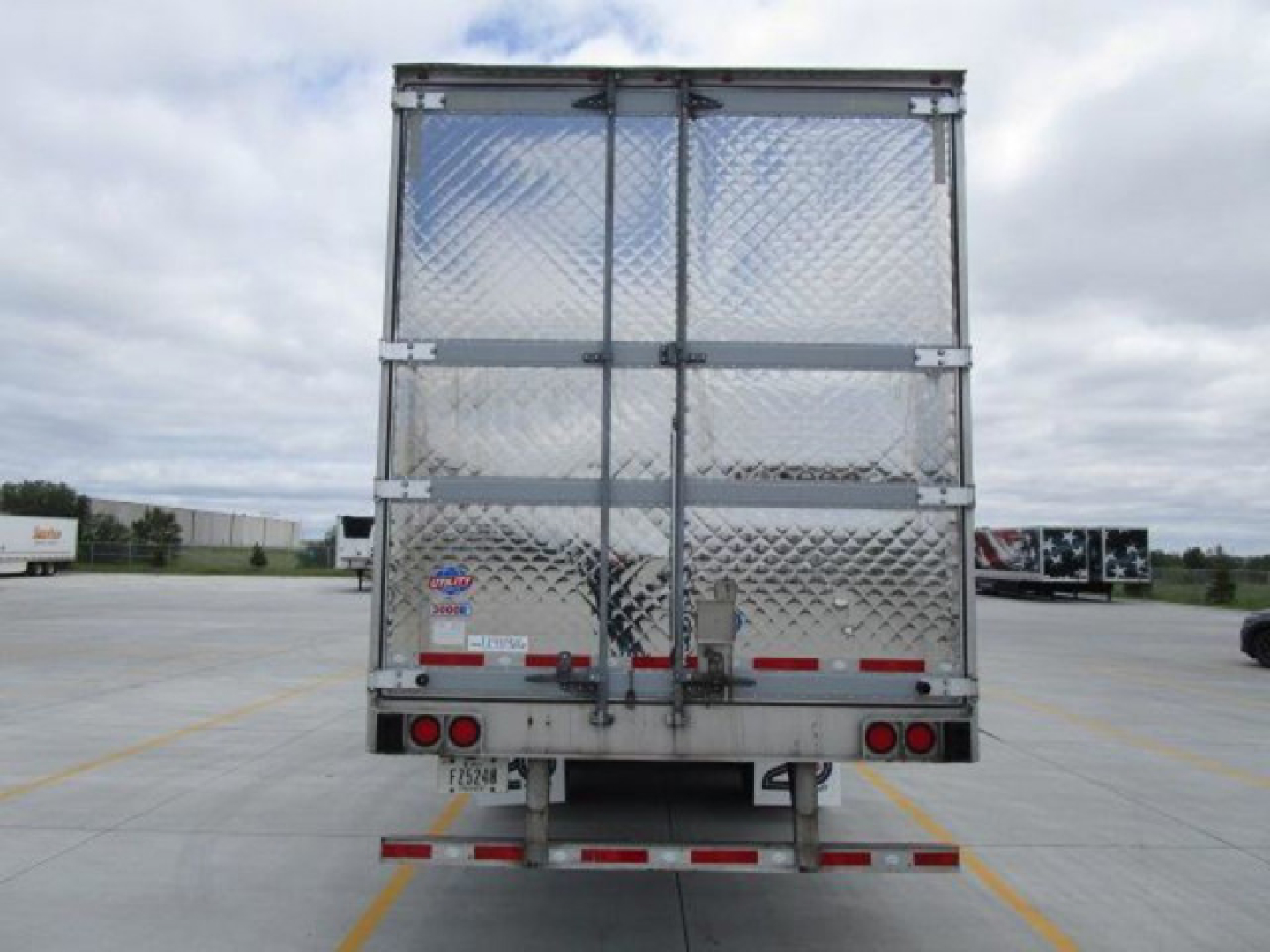 Rear view of a 2022 Utility Reefer trailer with diamond plate doors, rear bumper, and taillights.