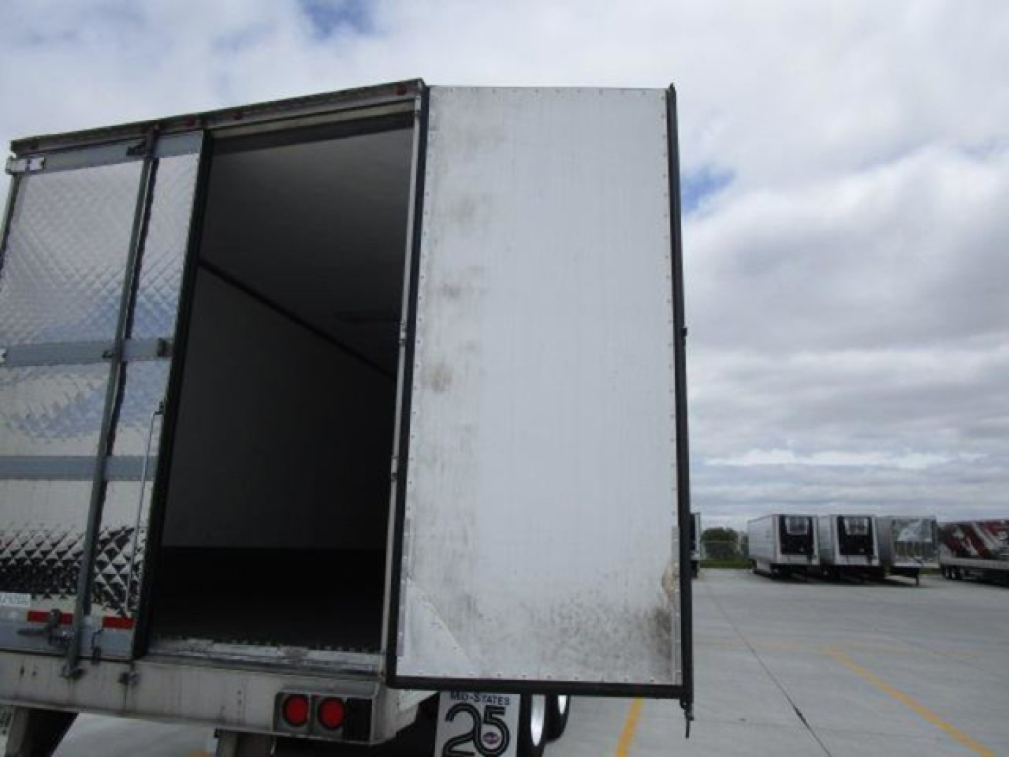 Utility reefer trailer showing rear doors open and cargo area visible.