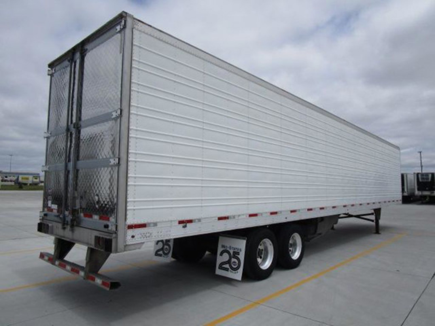 Trailer side view of a 2022 Utility refrigerated trailer with aluminum panels, triple axle, and rear doors.