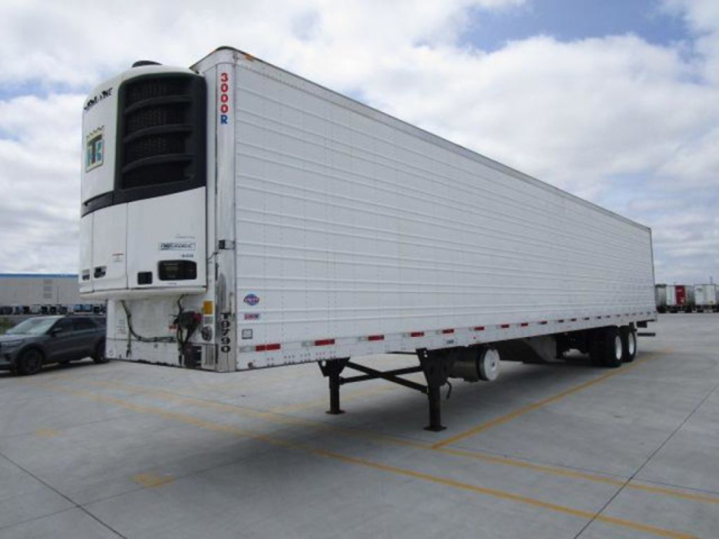Trailer trailer refrigeration unit at front with white body, side panels, and refrigeration unit mounted at front. Visible text on unit includes 'THERMO KING' style label and numbers '3000R' on vertical edge; trailer has no other legible la