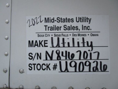 Sign on trailer showing 2022 Mid-States Utility Trailer Sales, Inc. with MAKE Utility logo, S/N N98467017, STOCK # U909926, VIN 3UTVS2530N8467017, and notes listing cities Sioux City, Sioux Falls, Des Moines, Omaha.