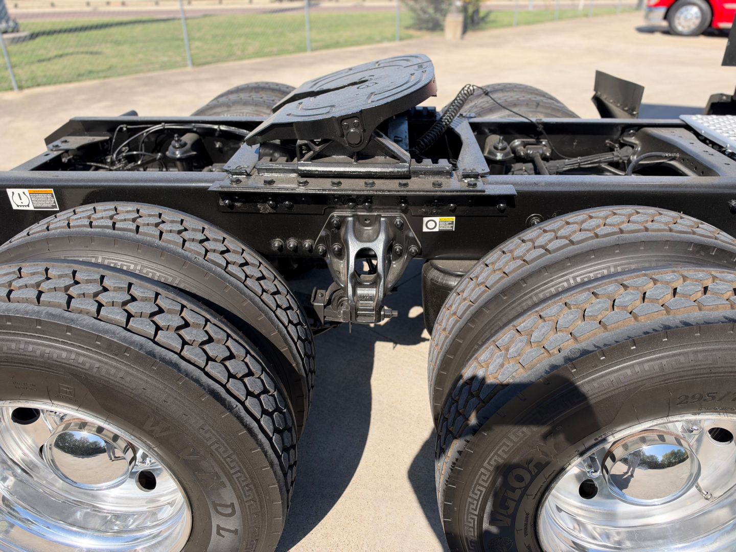Kenworth T680 truck chassis showing dual rear axles and fifth wheel mounting area.