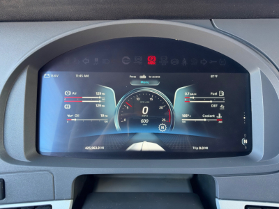 Kenworth T680 instrument cluster display showing digital gauges: left panel air/oil temps, center speedometer with 0, 6000, mileage 425963.9 mi, right panel fuel and DEF, ambient 87°F. Various warning/icons top.