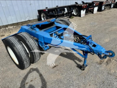 Blue Stoughton single axle dolly trailer chassis with dual rear wheels and hitch, showing VIN RB1821 and stock 7880.