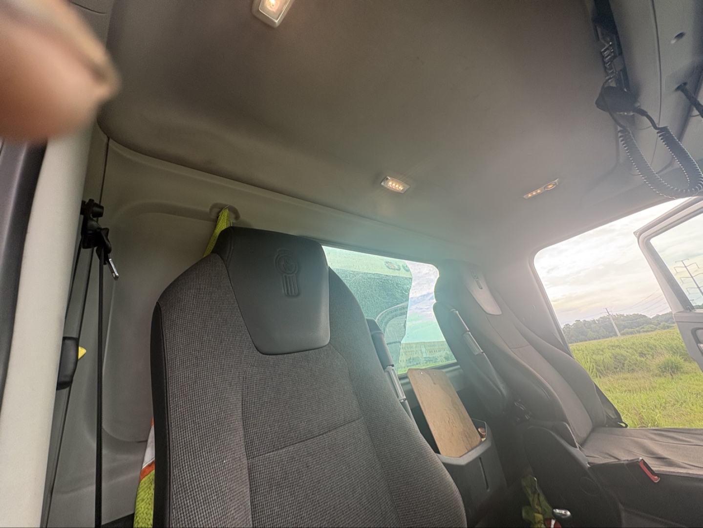 Cab interior of a Kenworth T880 truck showing driver's seat and overhead cabin area