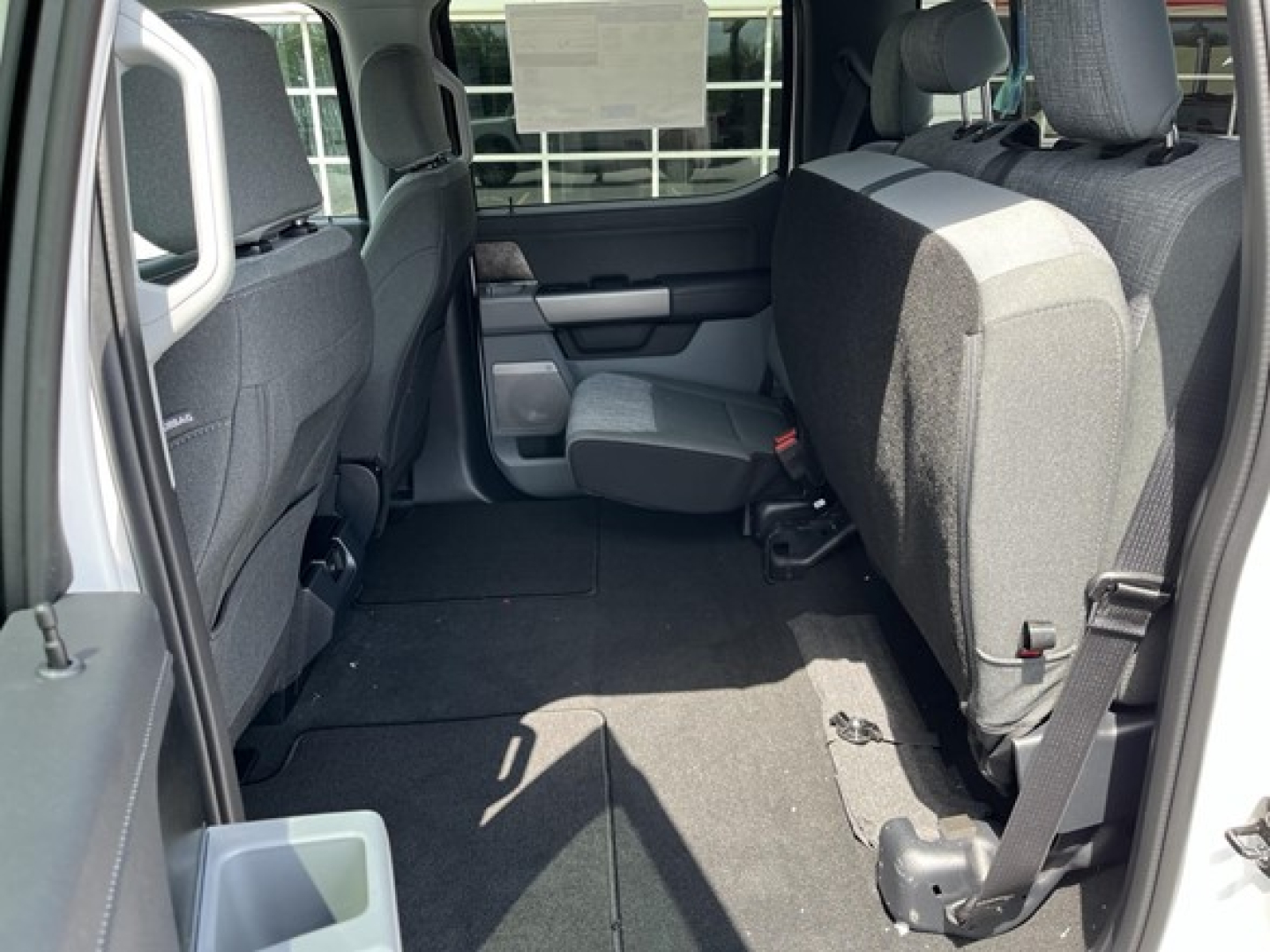 Ford F-350 interior rear seating area showing rear cargo space and folded second-row seats.