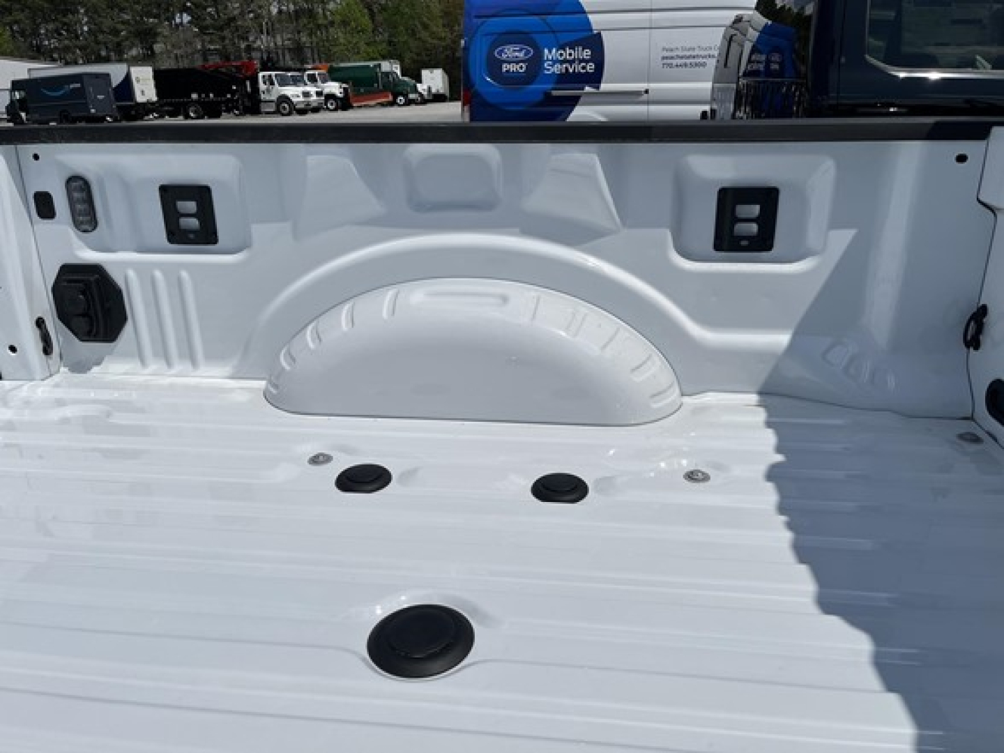 Ford F-350 truck bed showing cargo tie-down points and bed liner.