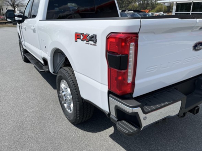 Ford F-350 Super Duty pickup rear quarter view showing 4x4 badge and chrome rear bumper.