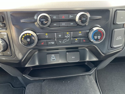Dashboard controls of a Ford F-350 truck showing climate control dials, radio, USB ports, 12V outlet, and center console area.