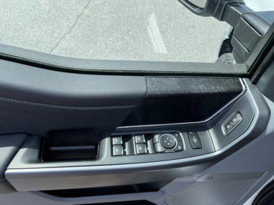 Ford F-350 door panel with window/seat controls and mirror adjustment near center console.
