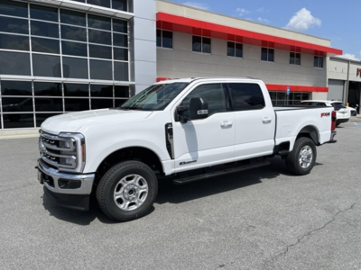 Ford F-350 pickup truck in white, extended cab, 2WD, side view showing front grille and wheel arches.