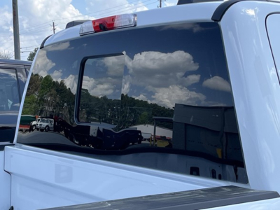 Ford F-350 pickup truck rear window and tailgate area in a parking lot.