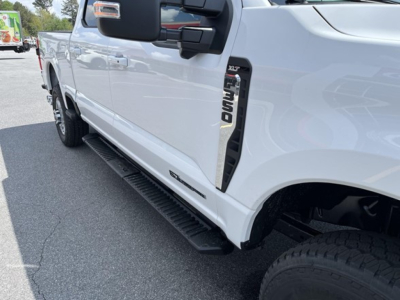 Ford F-350 pickups side view showing running board and XLT badge on front fender.