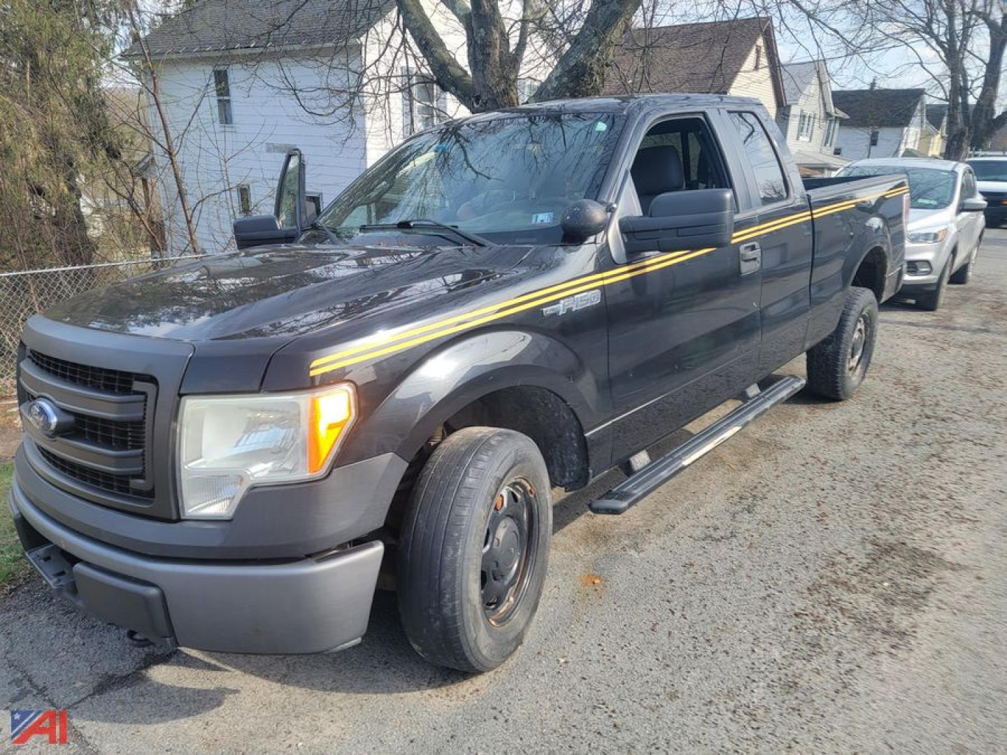 Ford F-150 extended cab pickup truck 2013 2WD with gray body and yellow stripe, front-left view showing single cab and long bed.