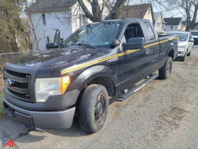 Ford F-150 extended cab pickup truck 2013 2WD with gray body and yellow stripe, front-left view showing single cab and long bed.