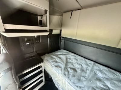 Kenworth T680 sleeper cab interior showing bunk bed and storage cabinets