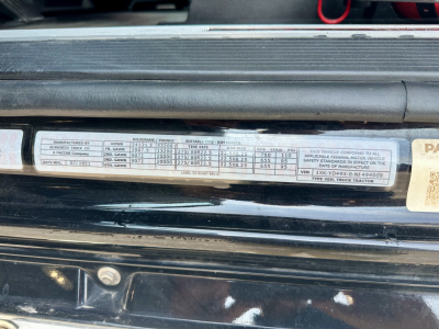Vehicle data plate on Kenworth truck showing multiple specification fields and numbers.