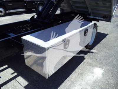 Isuzu NPR HD truck bed toolbox/storage box mounted on chassis with diamond plate surface and wheel visible
