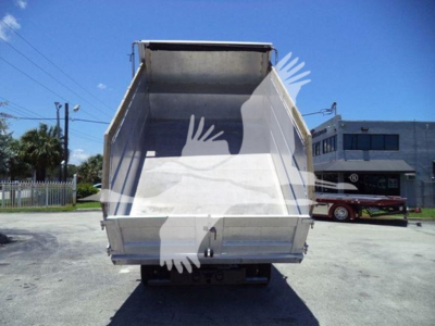 Isuzu NPR HD dump truck bed viewed from rear showing empty cargo area and tailgate.