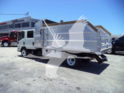 Isuzu NPR-HD dump truck rear/right side view showing dump bed with raised sides and white body.
