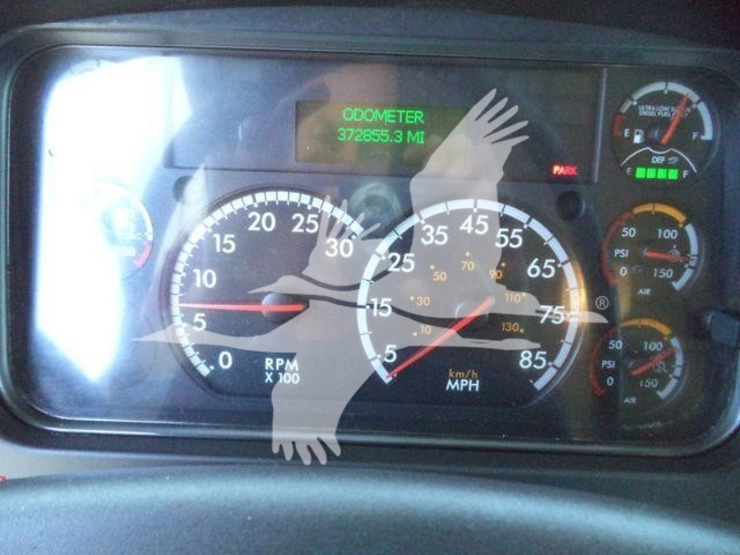 Vehicle dash gauge cluster showing speedometer, tachometer, and odometer reading 372,555.3 miles; assorted gauges and warning lights.