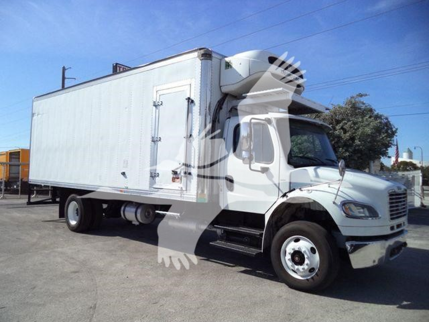 Freightliner M2 106 refrigerated truck with a white cab and box, front grille visible, side door and cargo box. No legible text on image.