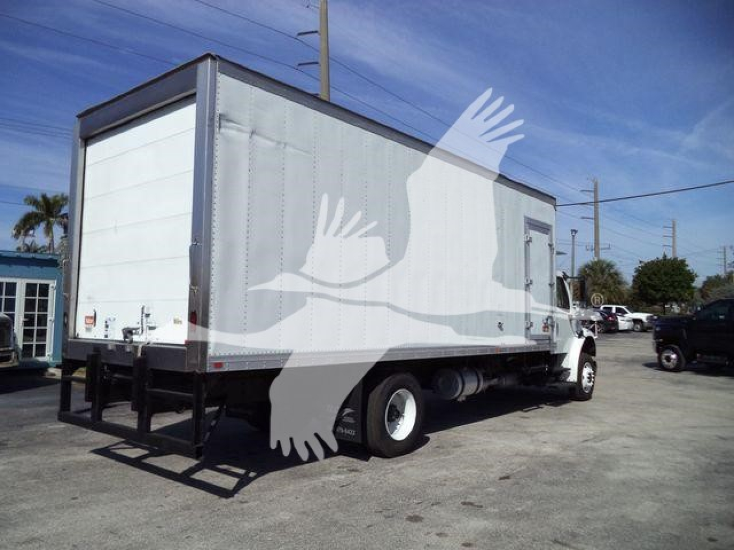 Truck refrigeration box on Freightliner M2 106 in-service with white box body and rear liftgate, side view