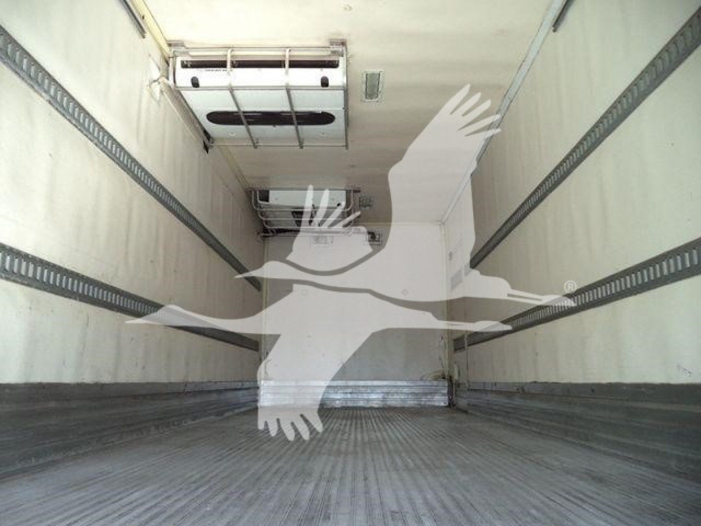 Truck cargo area of a 2016 Freightliner M2 106 refrigerated truck, inside trailer with metal ribs along walls and a rear floor, no text visible.