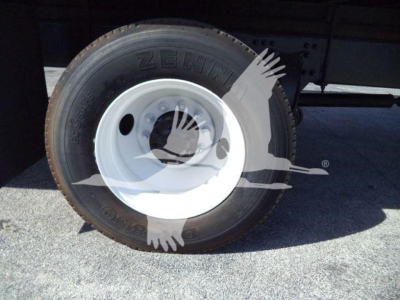 Rear wheel and tire of a Freightliner M2 106 truck showing white steel rim and Zenit? tire sidewall.
